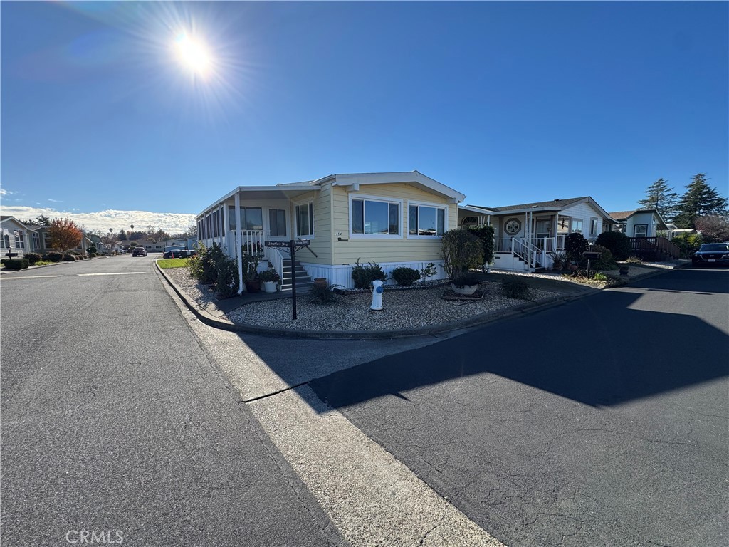 a front view of a house with yard and parking space