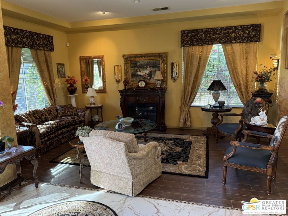 a living room with furniture a window and a fireplace