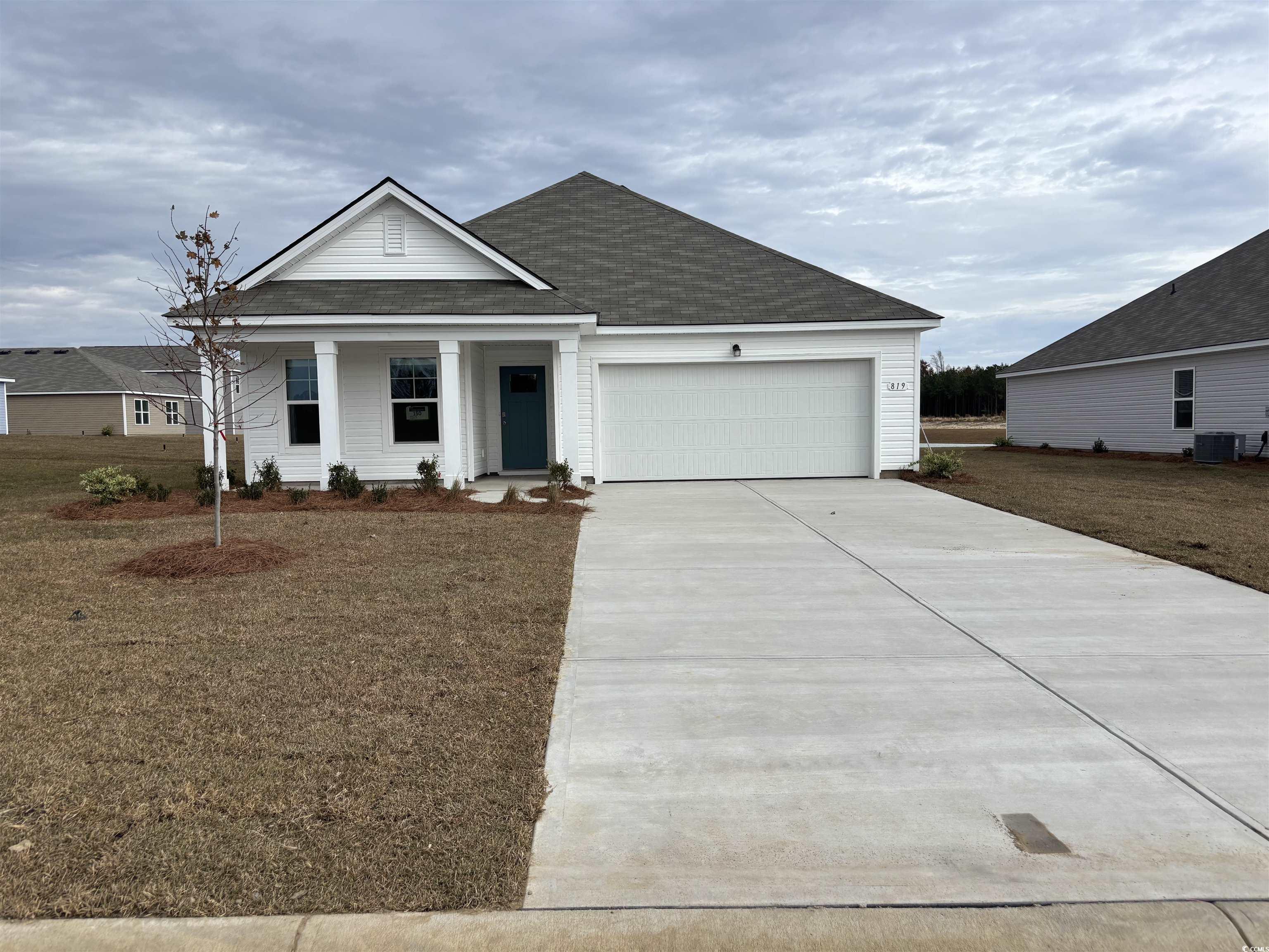 View of front of property with a garage and centra