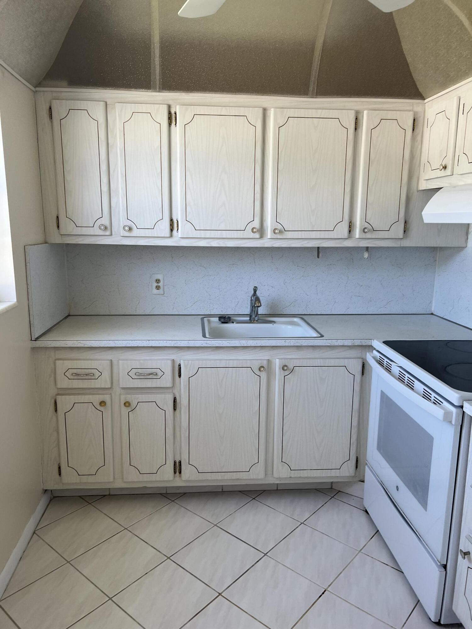 a kitchen with white cabinets