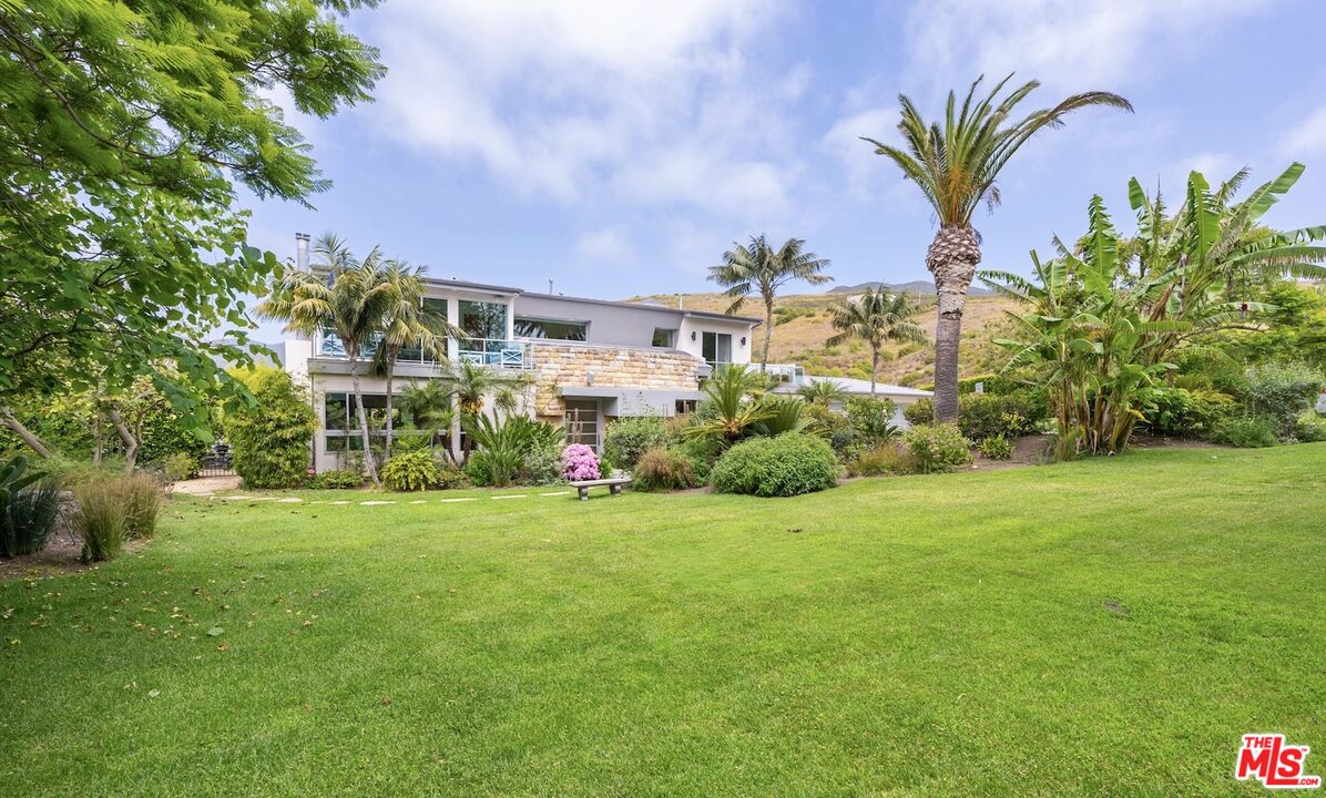 a view of a garden with a building in the background