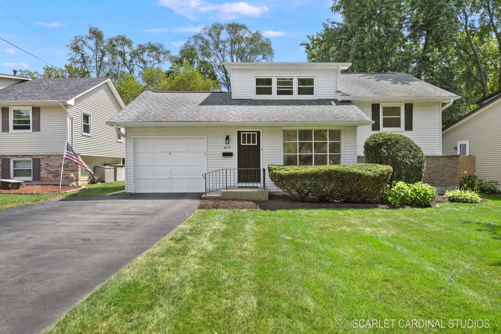 a front view of a house with a yard and garage