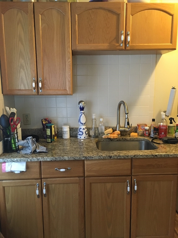 a kitchen with a sink cabinets and appliances