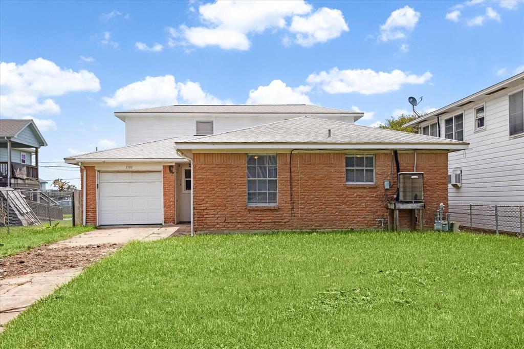 a front view of a house with a garden and yard