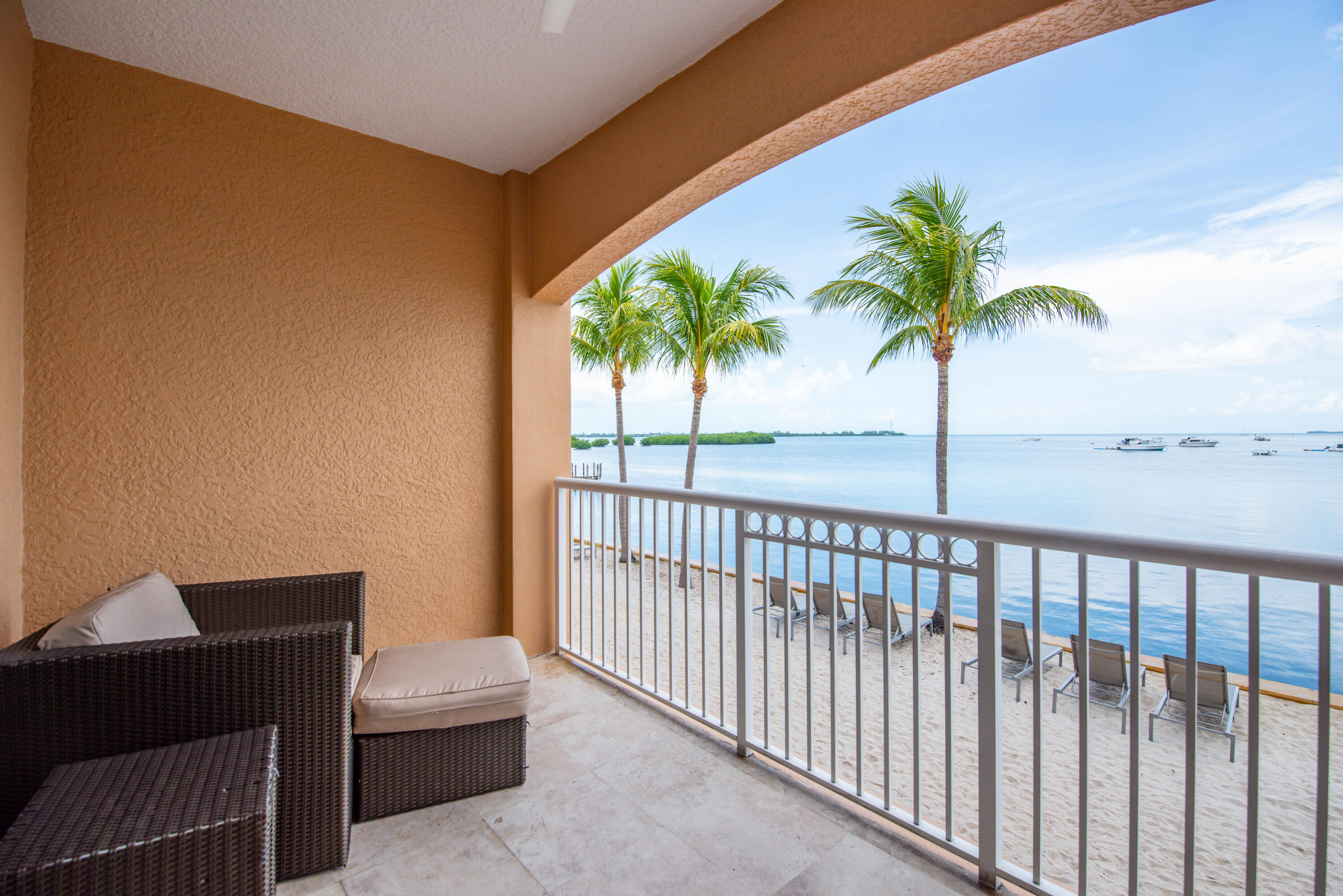 a view of a balcony with palm trees