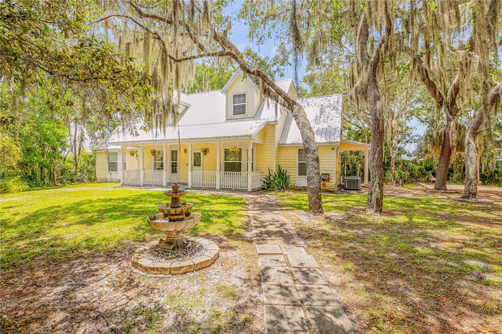 a house that has a tree in front of it