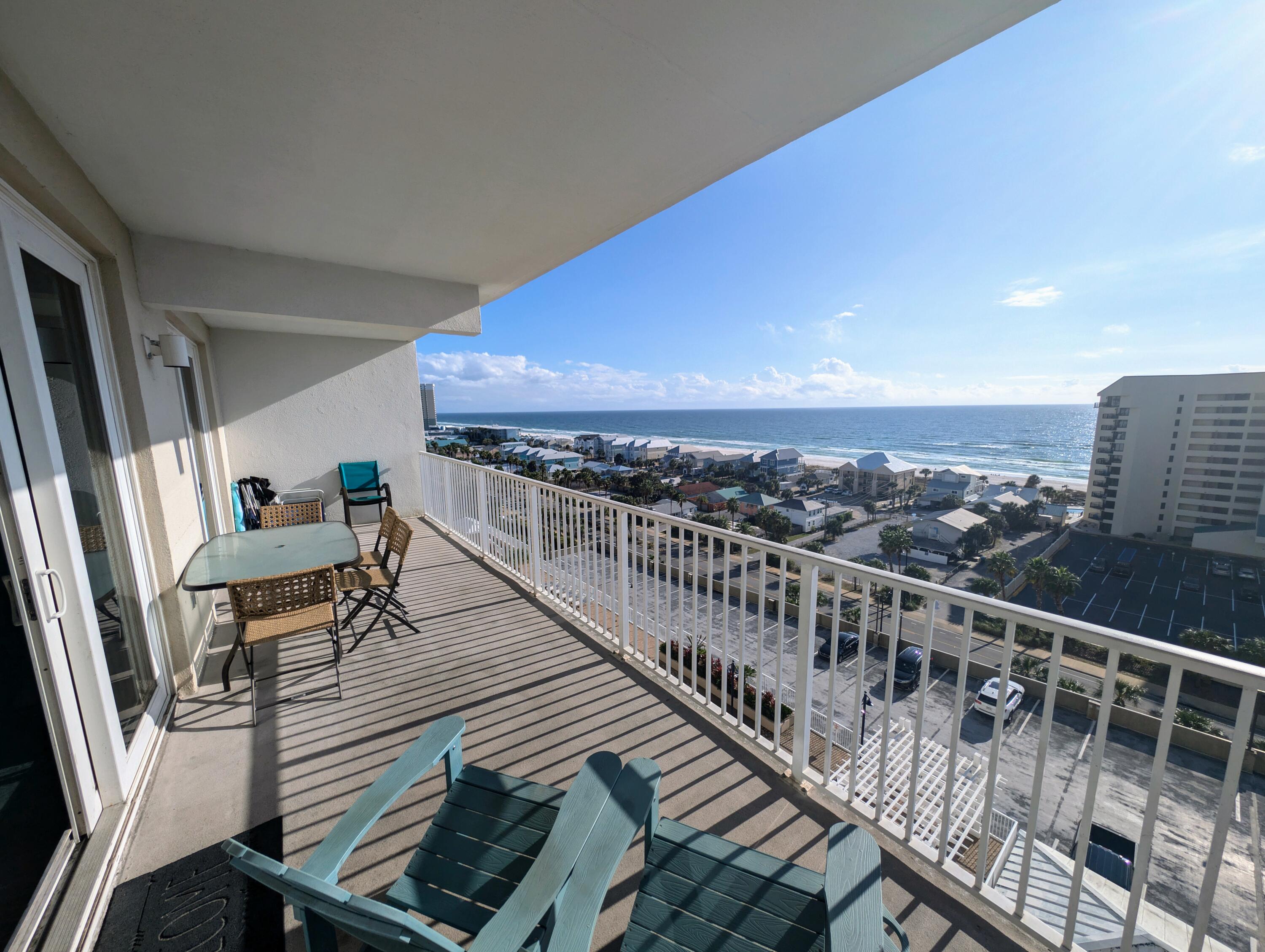 a view of balcony with wooden floor and seating space