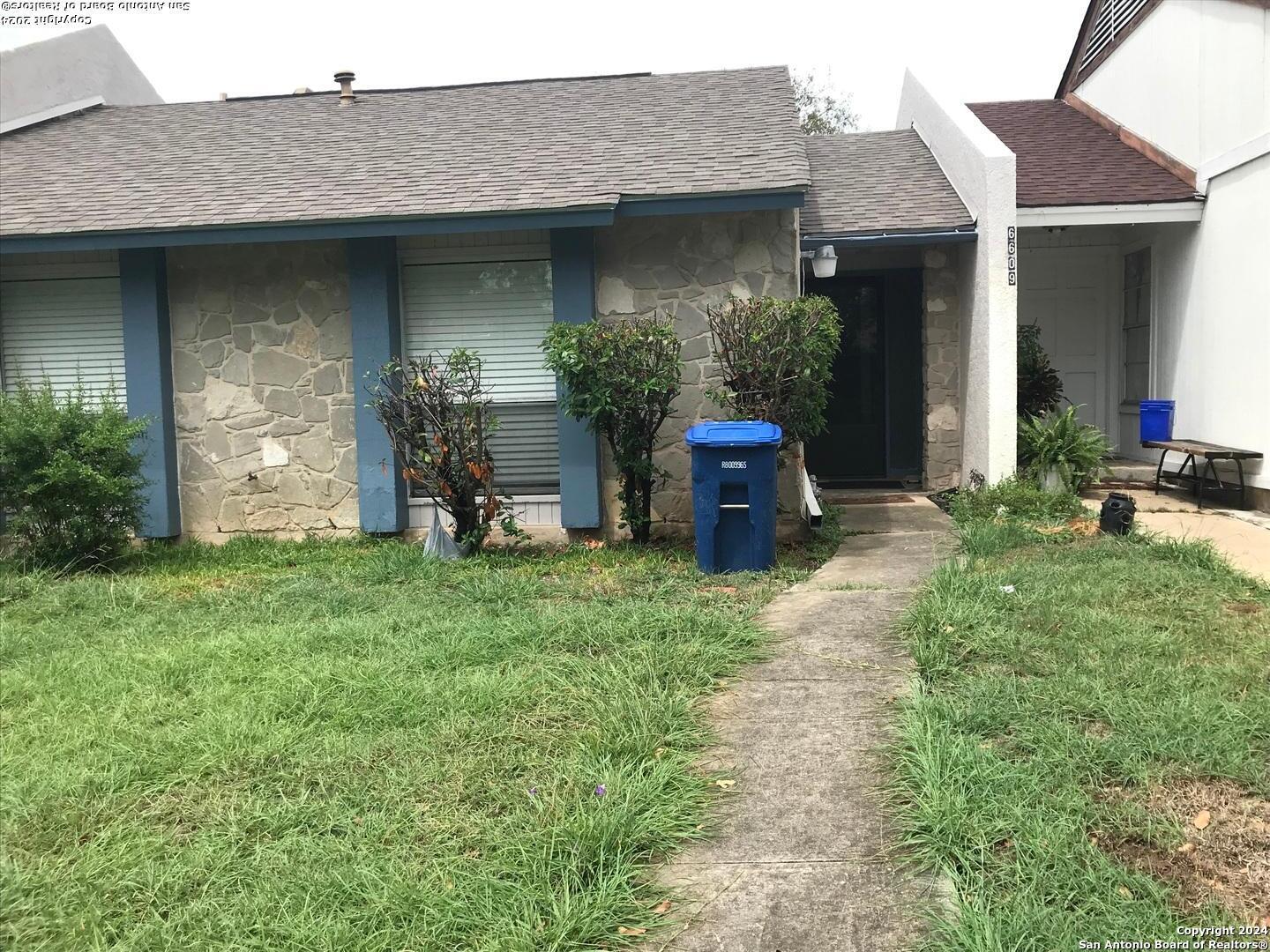 a front view of a house with a garden