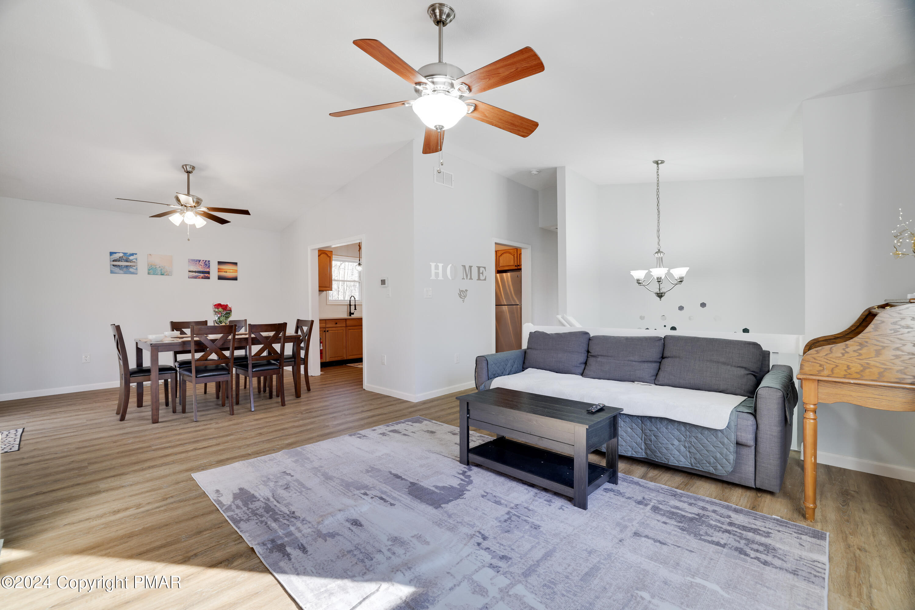 a living room with furniture and a chandelier