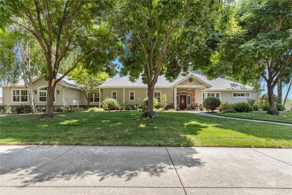 a front view of a house with a garden