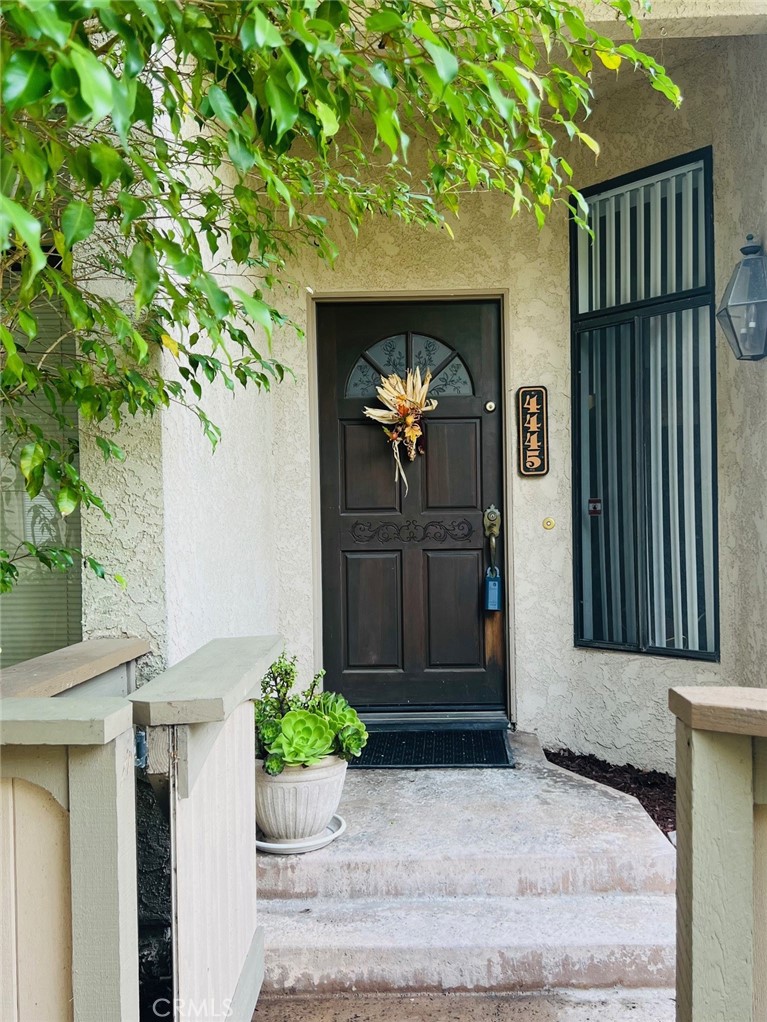 front view of a house with potted plants