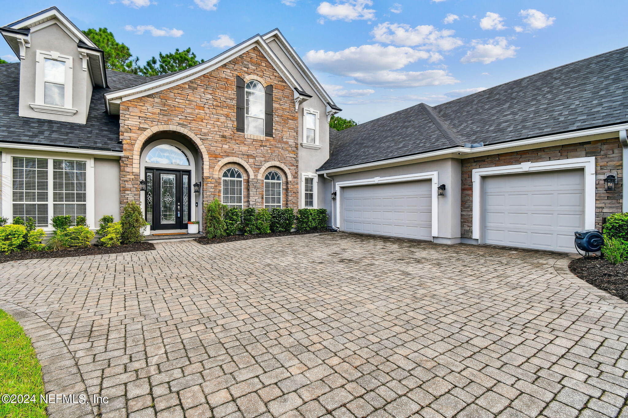 a front view of a house with a yard and garage