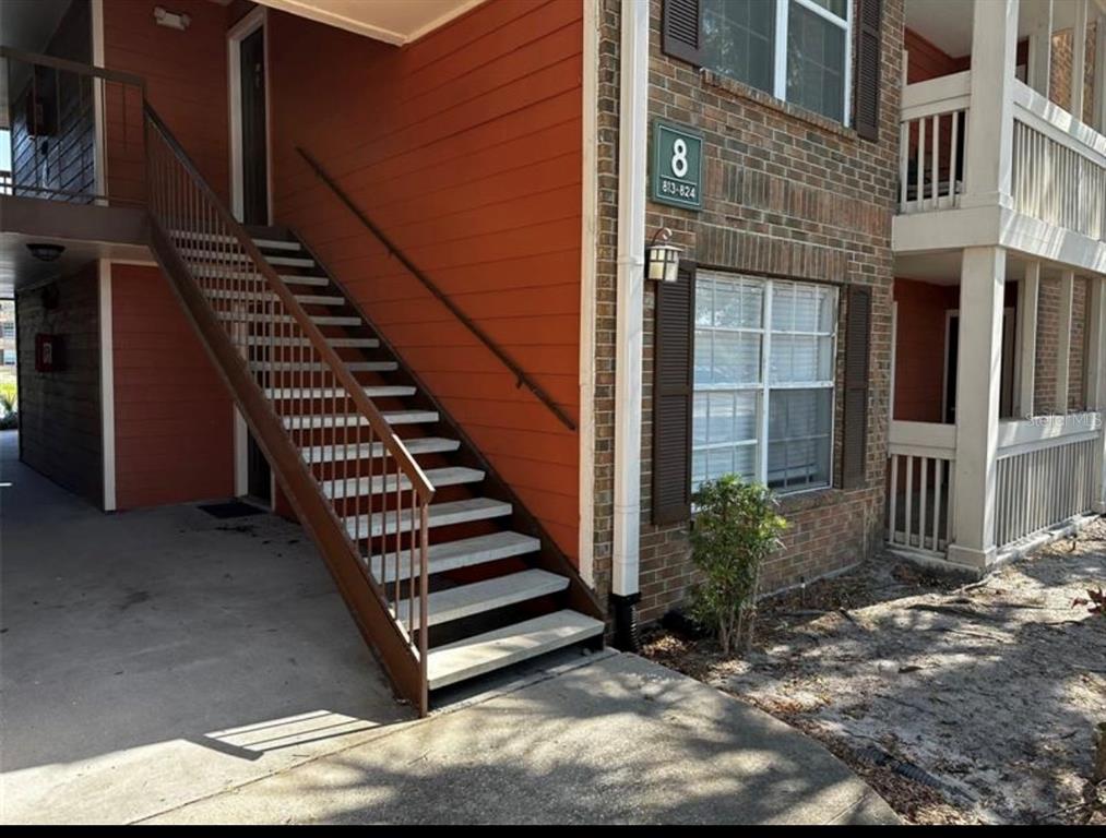 a view of a backyard with door and wooden floor