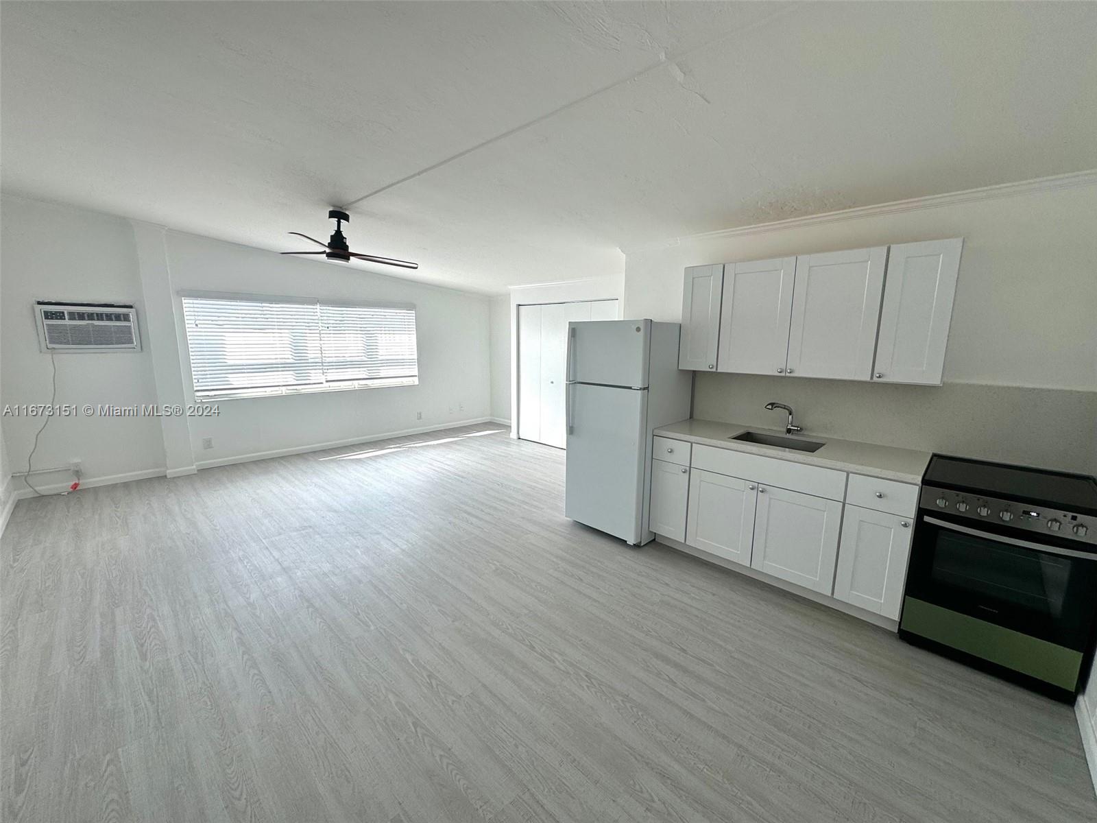 a kitchen with stainless steel appliances a stove a sink and a refrigerator