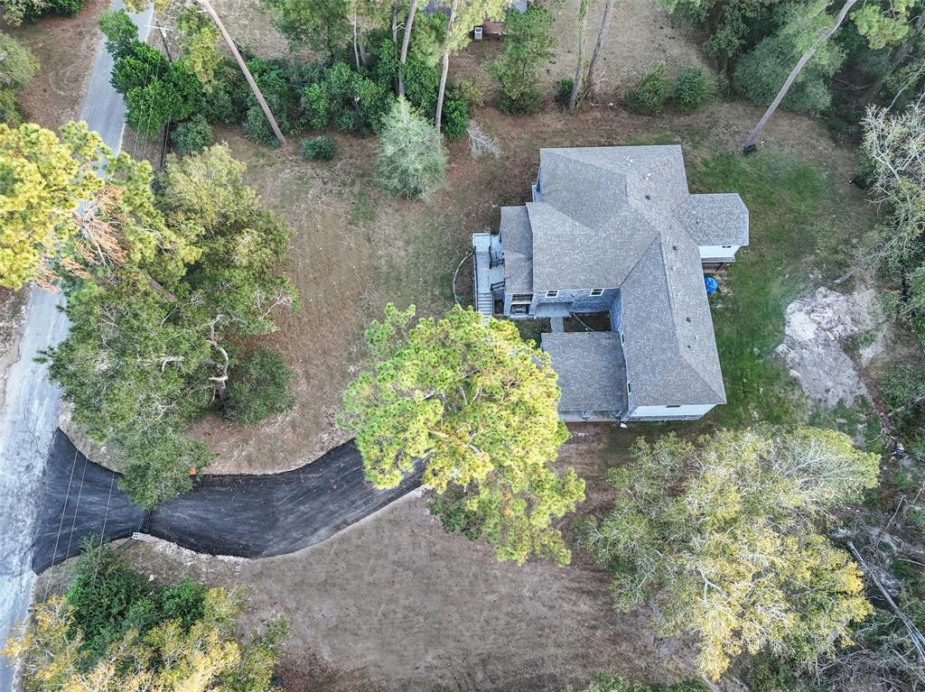 an aerial view of a house with a yard and a fountain