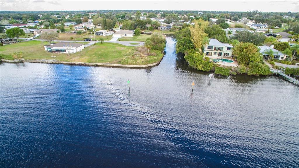 an aerial view of residential houses with outdoor space and swimming pool