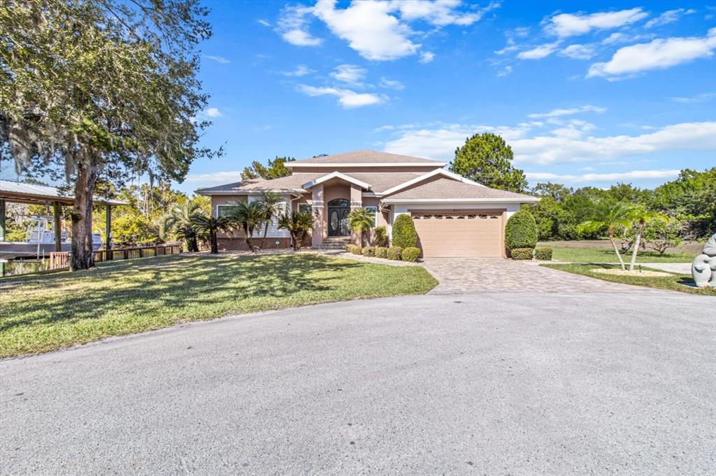 a front view of a house with a yard and garage