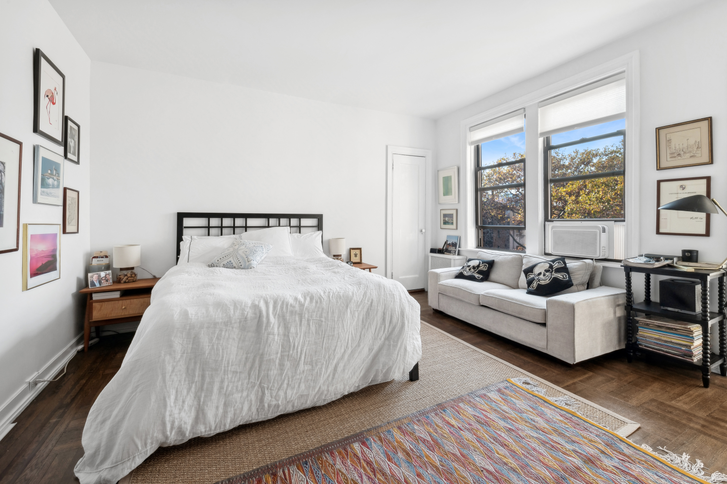 a spacious bedroom with a bed couch and a window