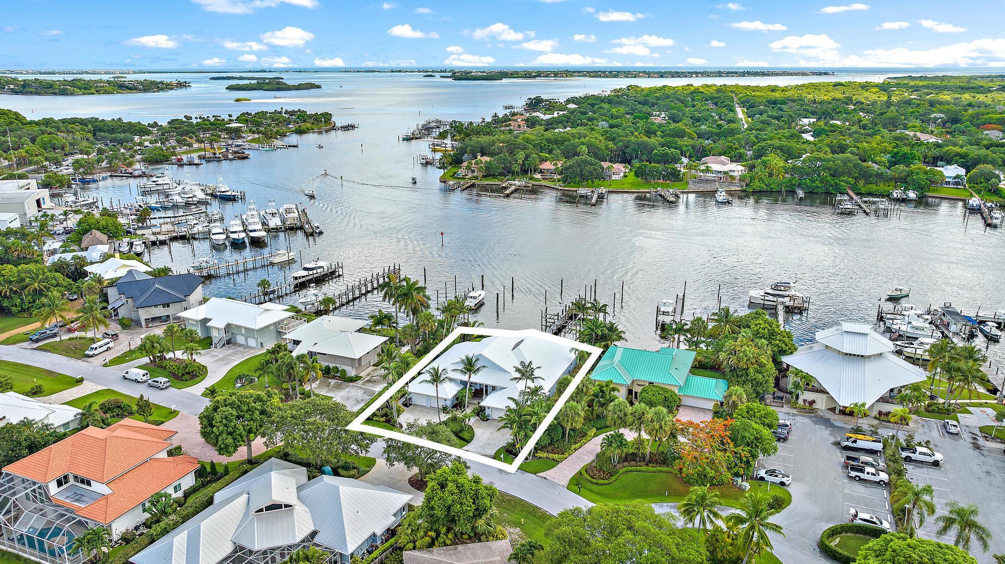 an aerial view of lake and residential houses with outdoor space