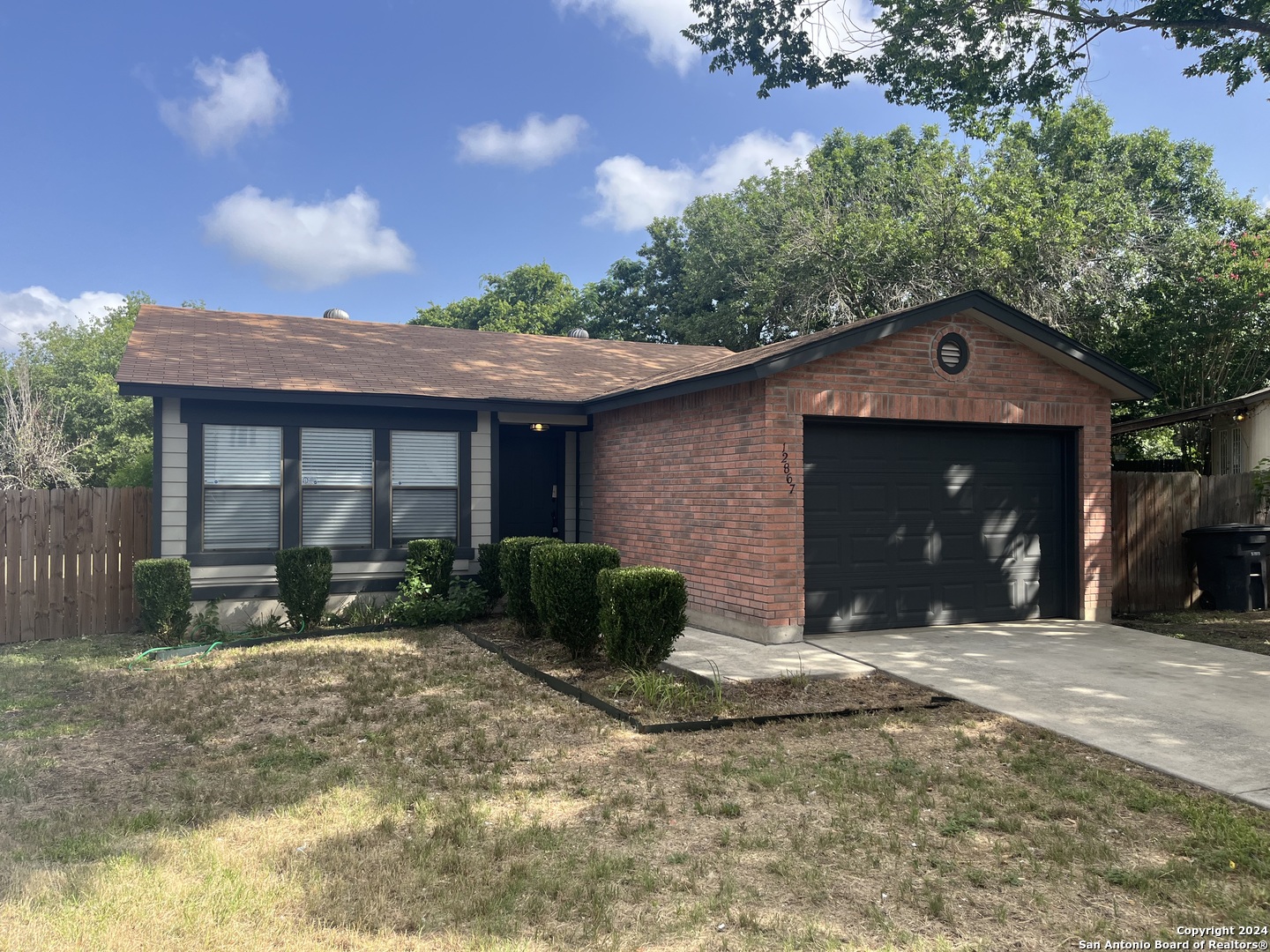 a front view of a house with a yard and outdoor seating