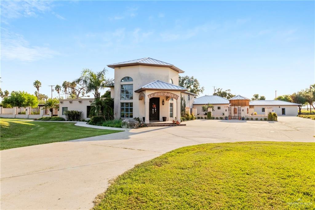 a view of house with outdoor space and swimming pool