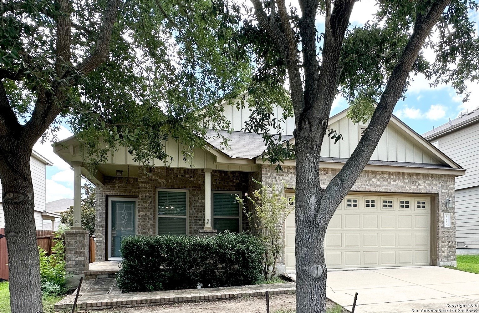 front view of a house with a tree