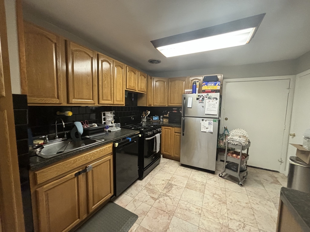 a kitchen with a sink cabinets and stainless steel appliances