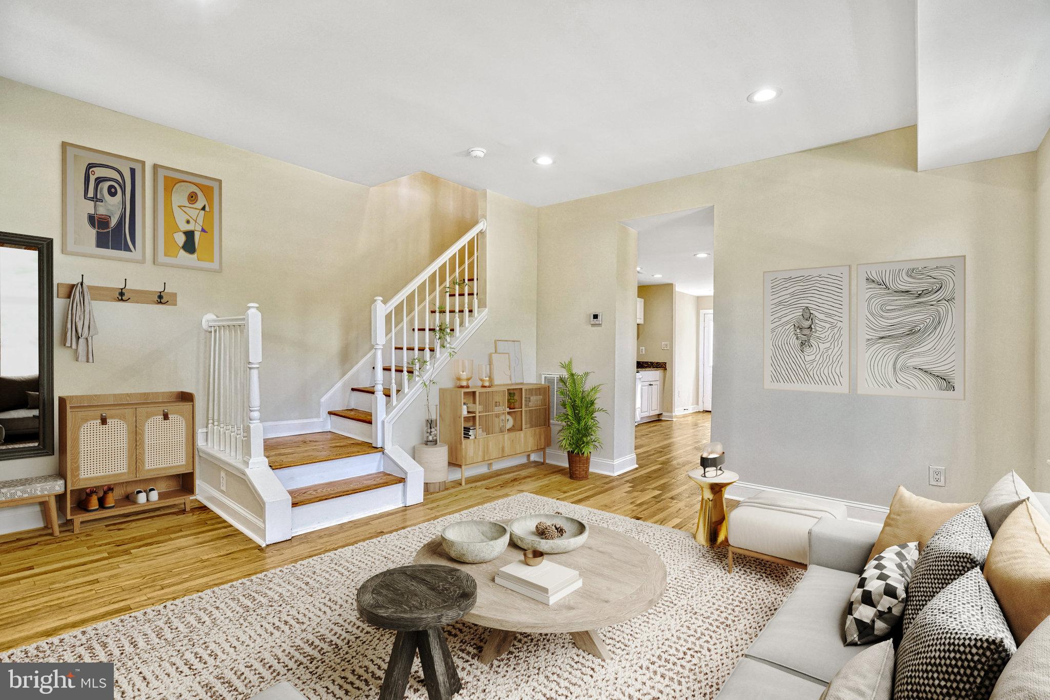 a living room with furniture and wooden floor