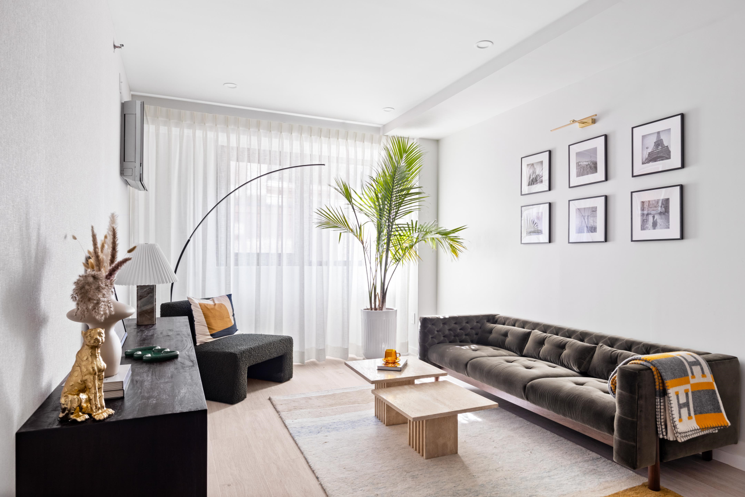 a living room with furniture flowerpot and wooden floor