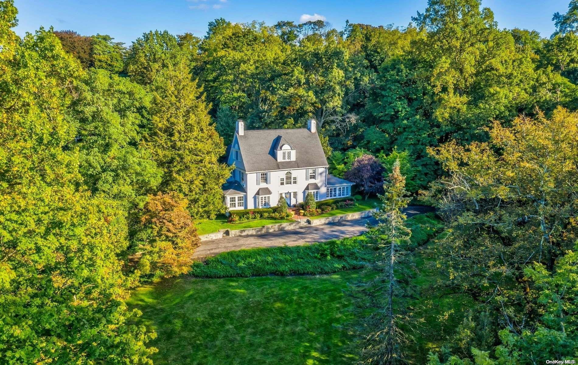 an aerial view of a house with swimming pool and garden view