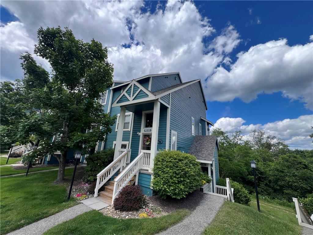 a front view of a house with garden