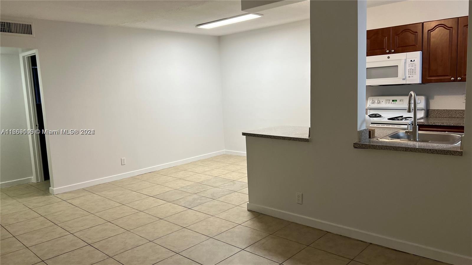 a kitchen with stainless steel appliances a refrigerator and a stove top oven