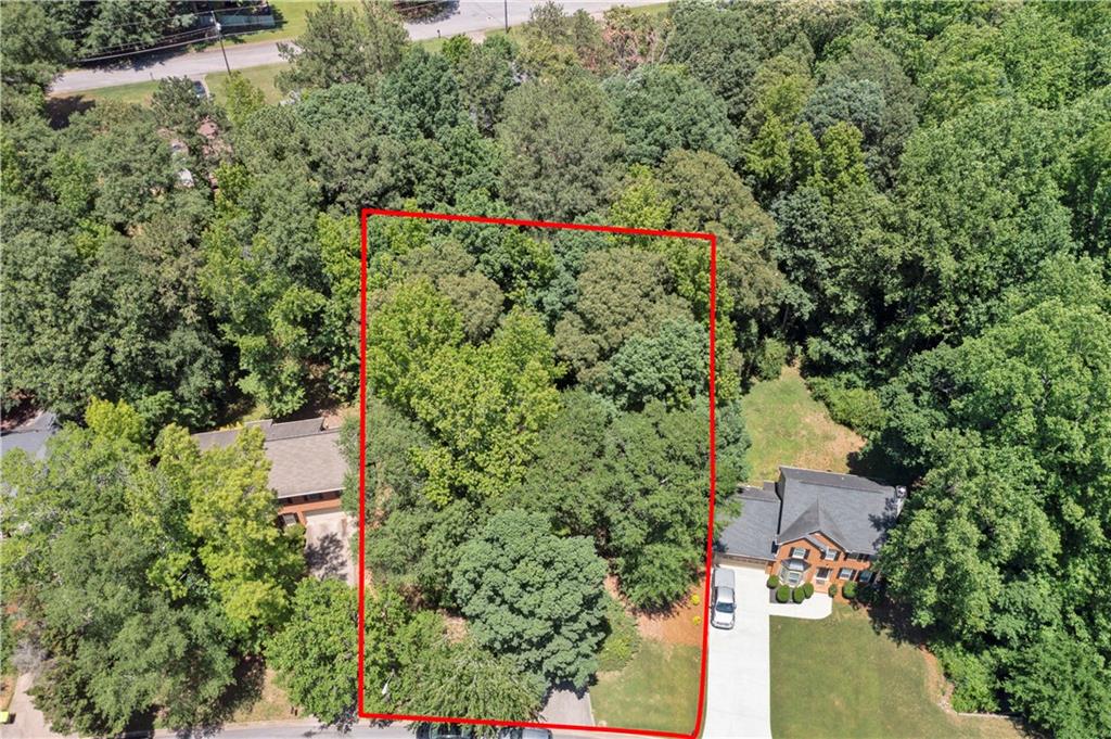 an aerial view of residential house with outdoor space and trees around