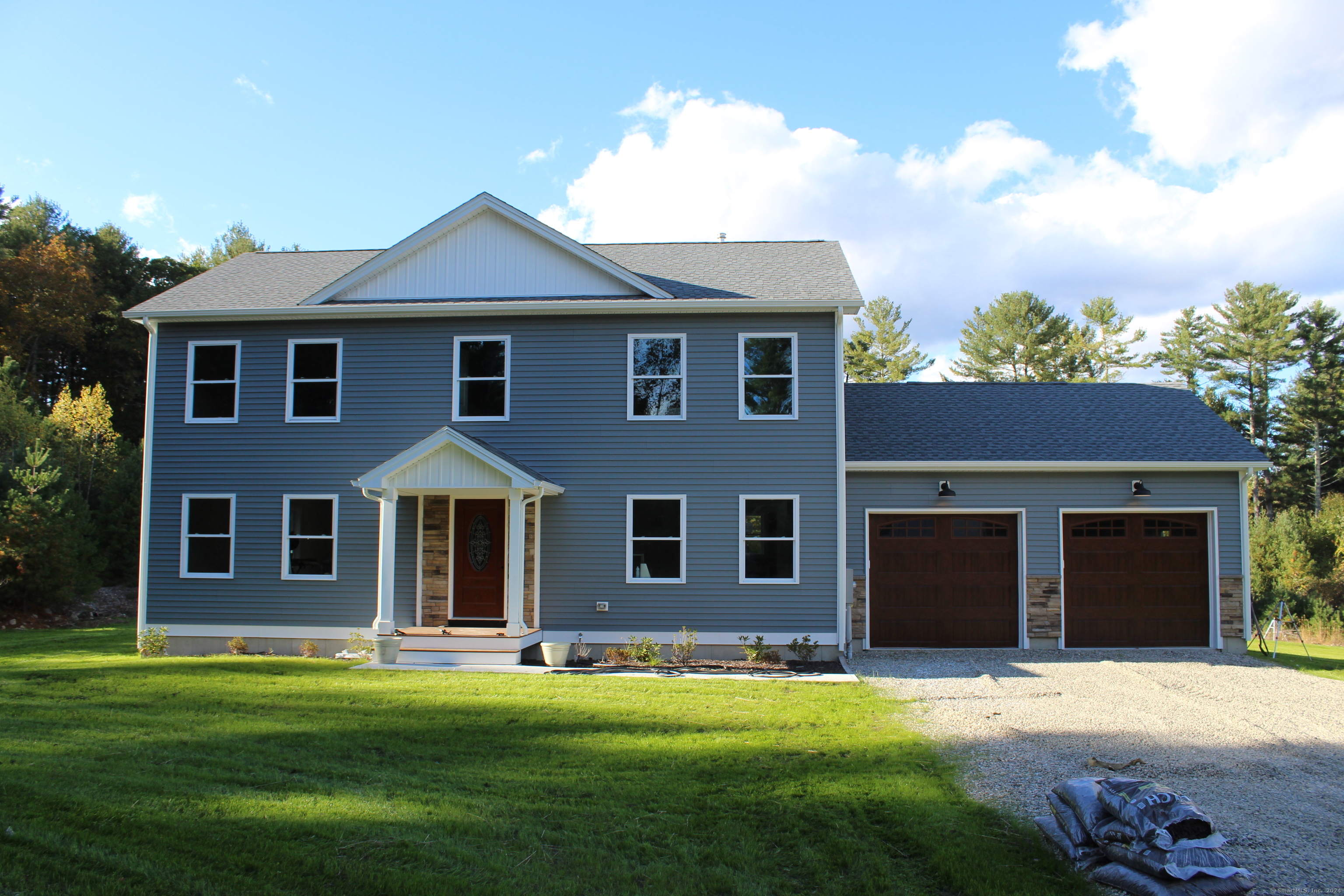 a front view of a house with a yard