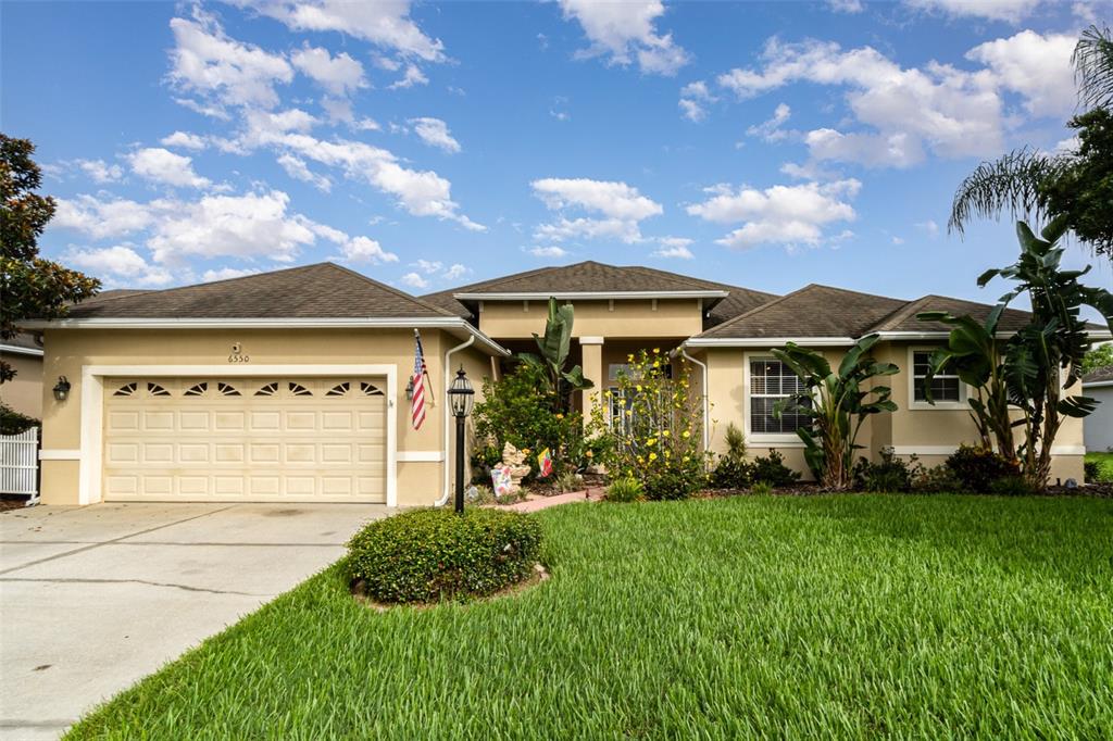 a front view of a house with a garden and yard