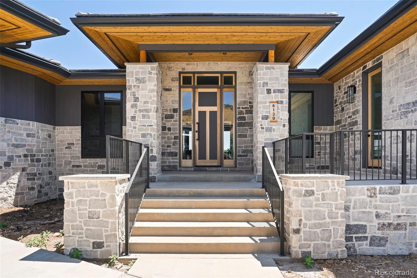 a front view of a house with a fountain