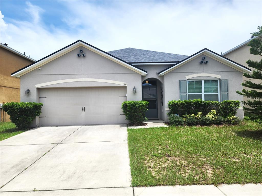 a front view of house with yard and green space