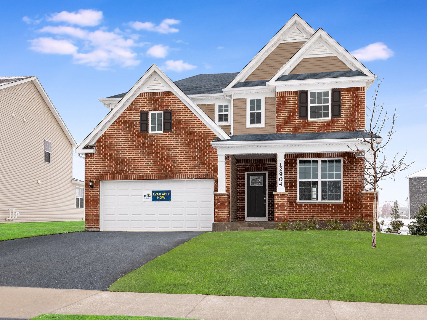 a front view of a house with a yard and garage