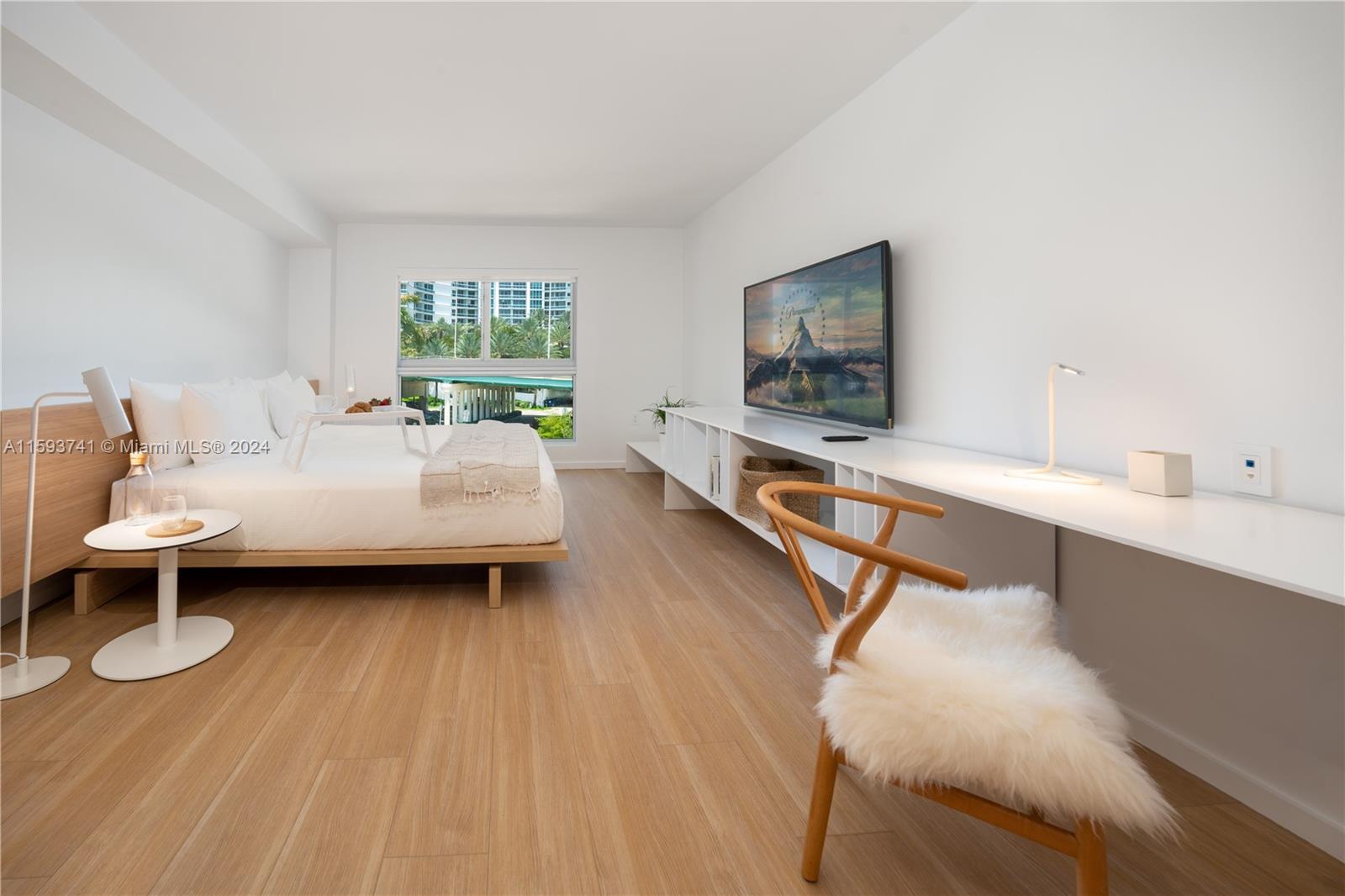 a living room with furniture a window and a flat screen tv