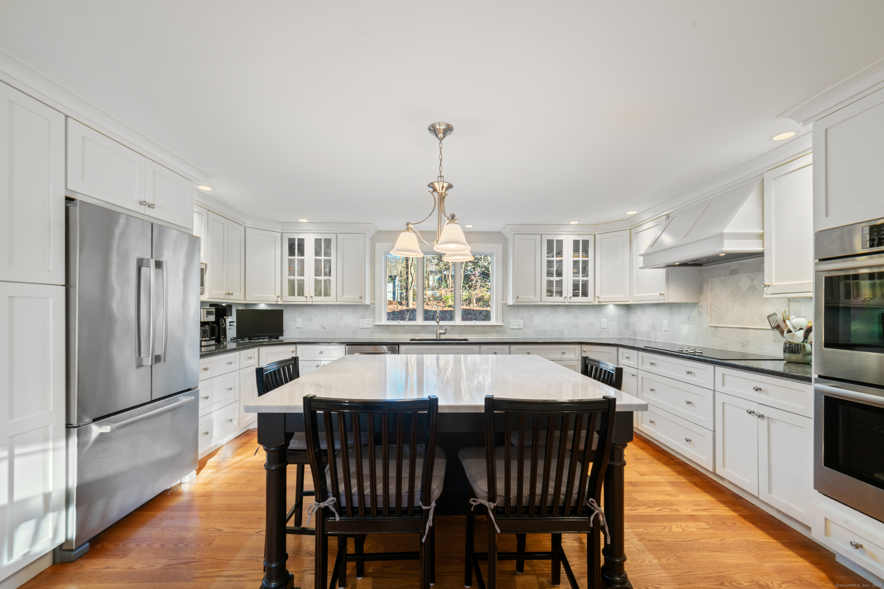 a large kitchen with a table and chairs