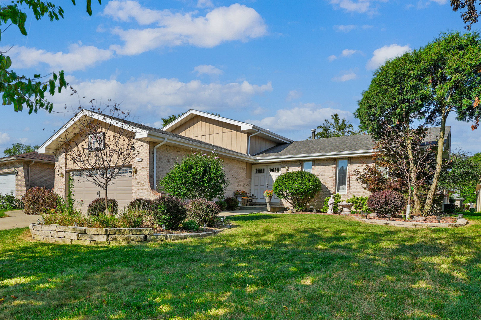 a front view of house with yard and green space