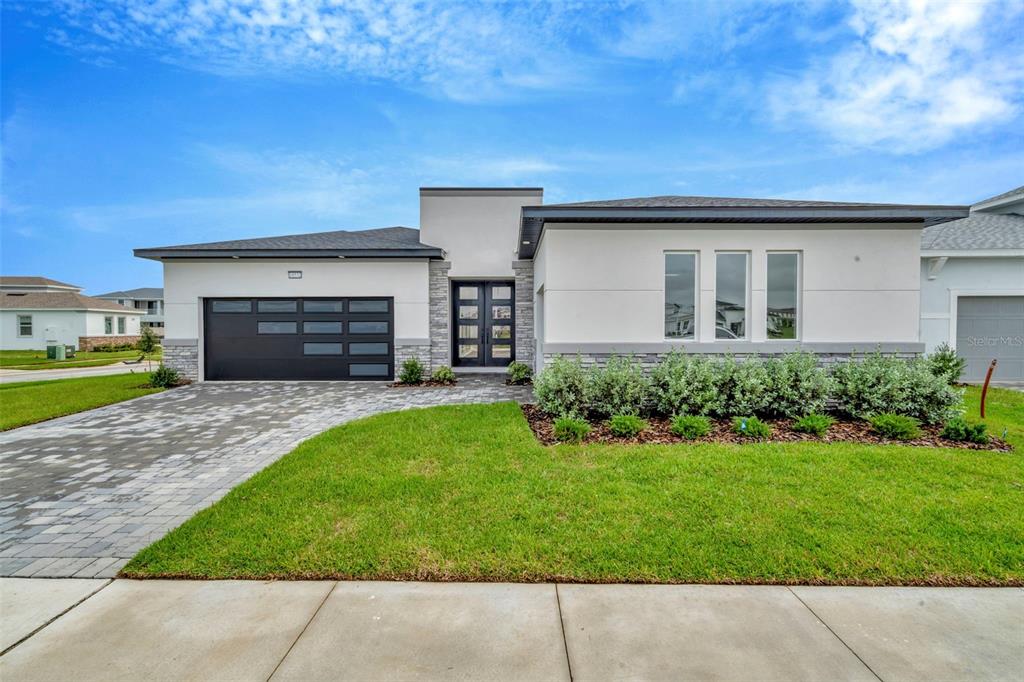 a front view of a house with a yard and garage