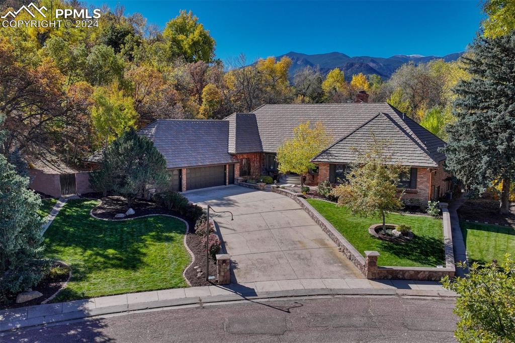 a aerial view of a house with a yard and potted plants