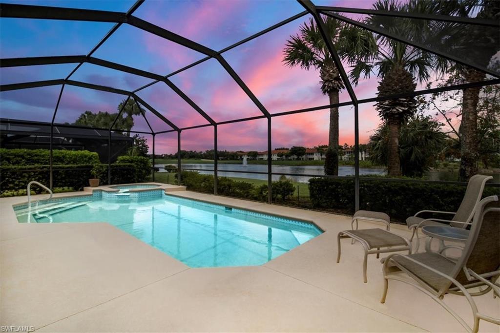 a view of a swimming pool with a chair and table in the patio