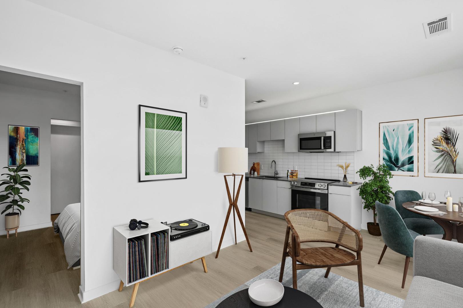 a kitchen with stainless steel appliances a table and chairs in it