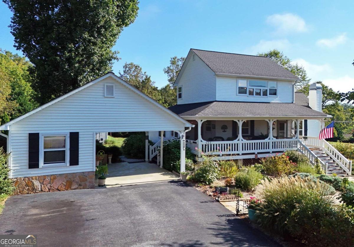 a front view of a house with a garden