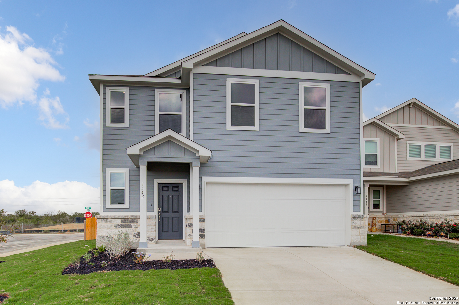 a front view of a house with a yard and garage