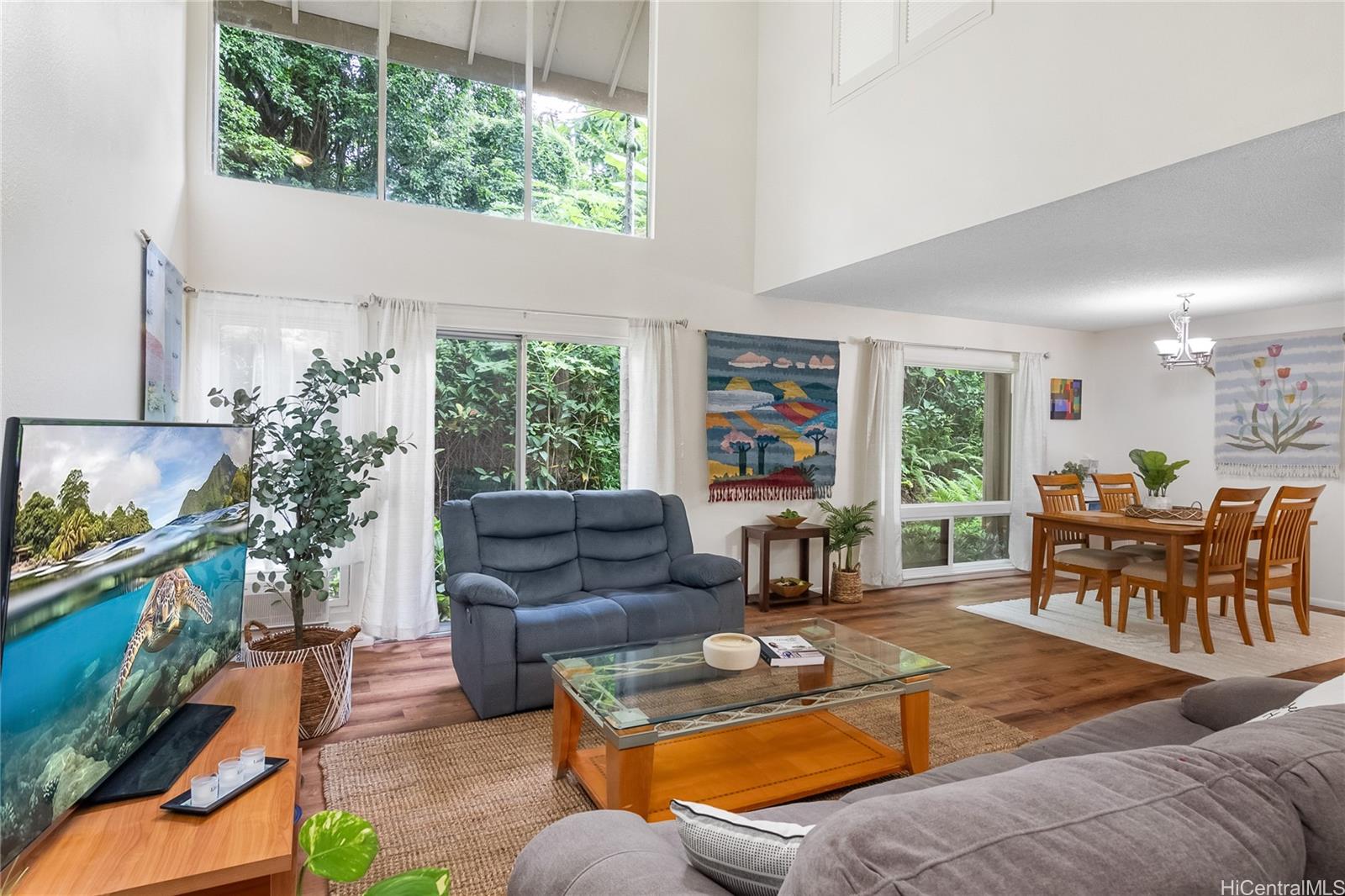 a living room with furniture fireplace and a large window