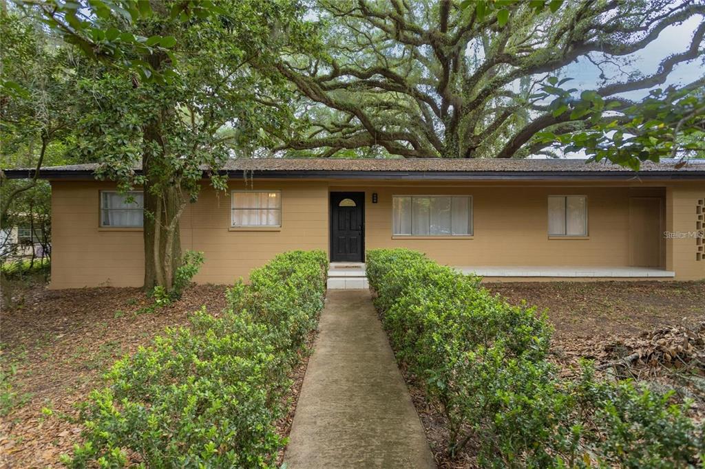 a front view of house with yard and trees