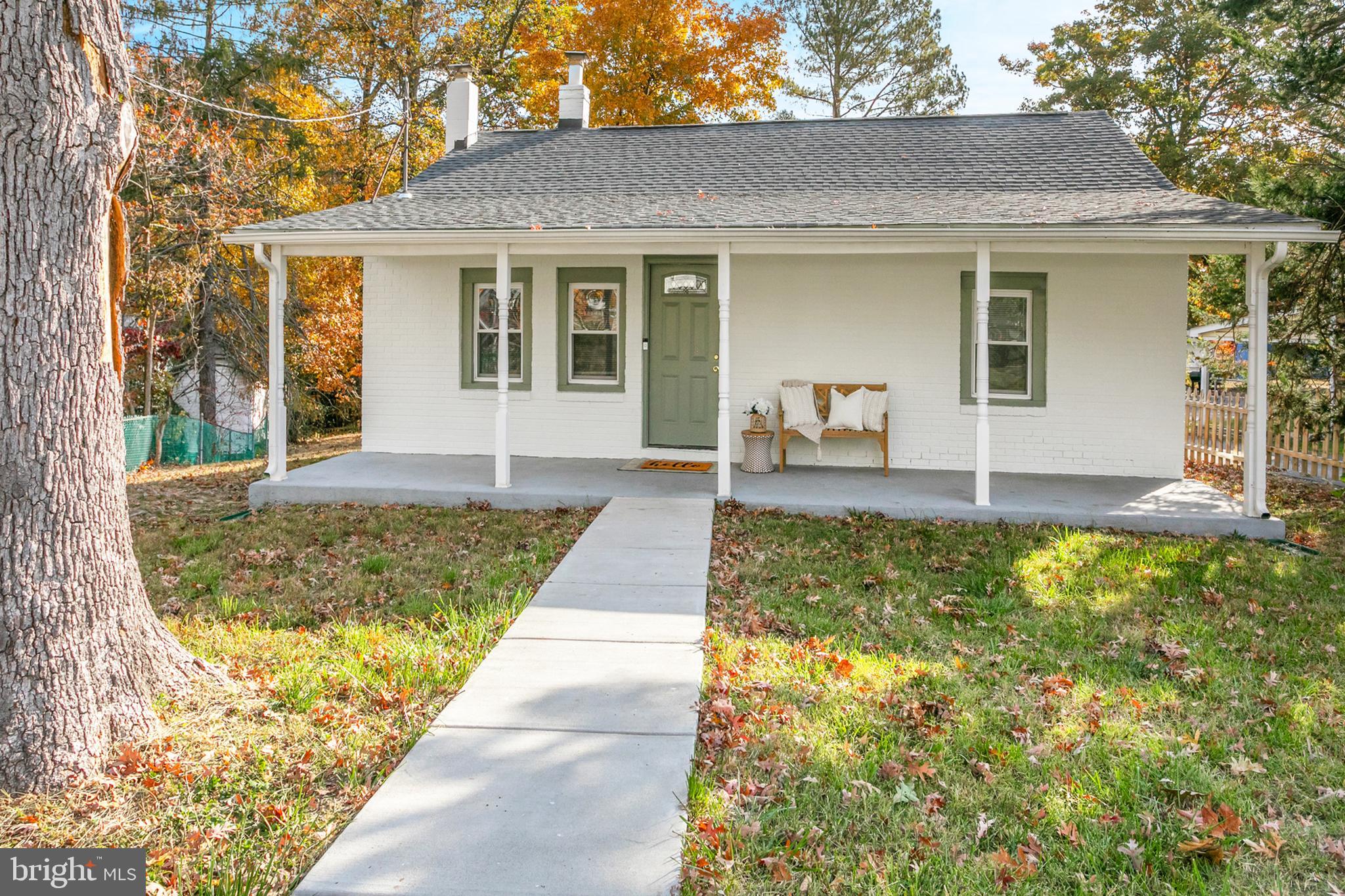 a front view of house with yard outdoor seating and barbeque oven